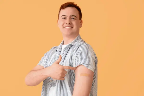 Young Man Showing Arm Applied Medical Patch Beige Background Vaccination — Stock Photo, Image