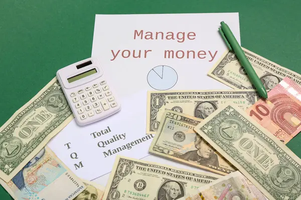 Paper with text MANAGE YOUR MONEY, money and calculator on green background