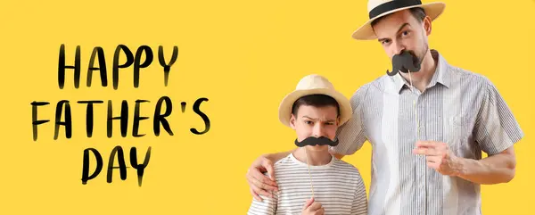 Happy little boy and his dad with paper mustache on yellow background. Greeting banner for Father\'s Day