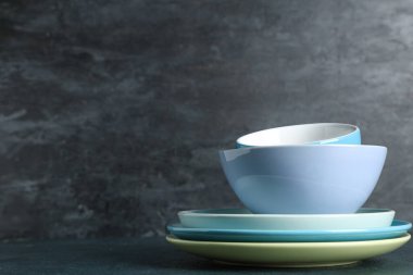 Masada siyah grunge arkaplanına karşı temiz sofra takımı yığını