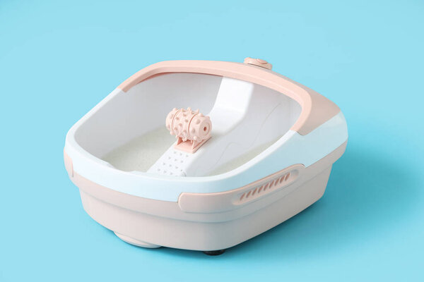 Massage foot bath on blue background