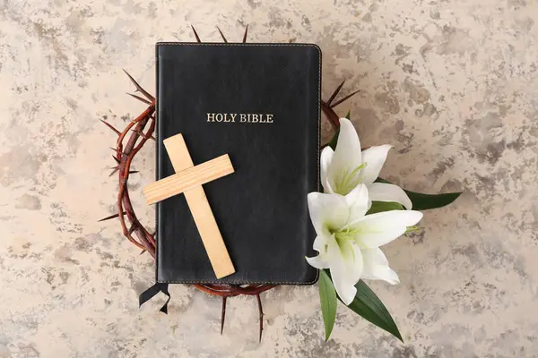 stock image Wooden cross, Holy Bible and white lilies on light grunge background