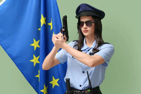 Female police officer with gun and flag of EU on green background