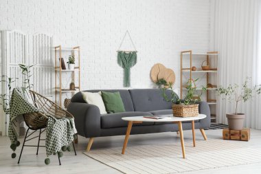 Bambu saplı ve kanepeli modern oturma odasının içi aydınlık.