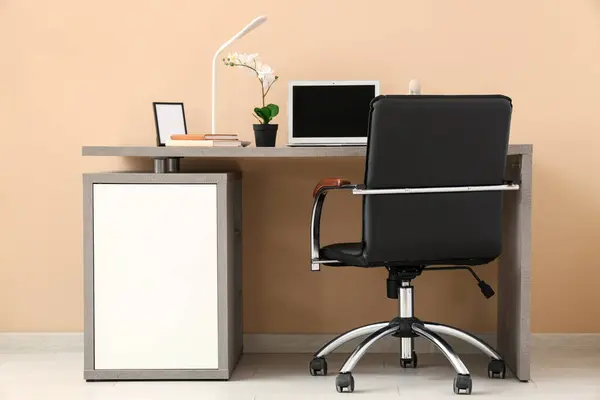Stylish Workplace Modern Laptop Armchair Houseplant Lamp Beige Wall Office Royalty Free Stock Images