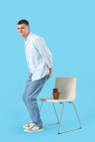 Young Man Hemorrhoids Cactus Chair Blue Background — Zdjęcie stockowe