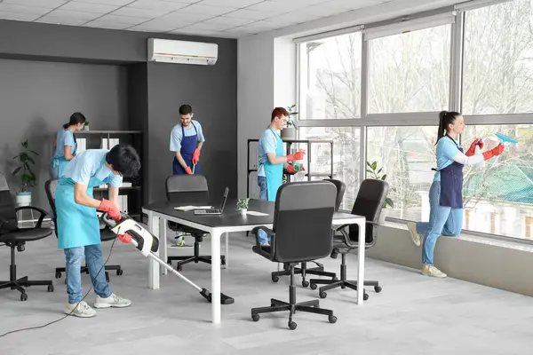 stock image Team of janitors cleaning in office