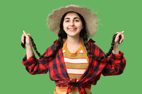 stock image Beautiful young happy woman in straw hat on green background. Festa Junina (June Festival) celebration