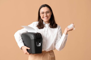 Bej arkaplanda kağıt öğütücüsü olan sekreter