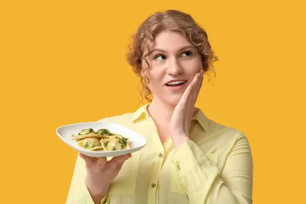 Thoughtful Young Woman Plate Tasty Ravioli Yellow Background Imagen de archivo