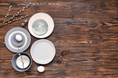 Paskalya yumurtaları ve ahşap arka planda söğüt dalları olan masa ayarı