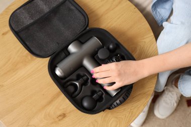 Evdeki masadan perküsyon masajı yapan genç bir kadın, yakın plan.