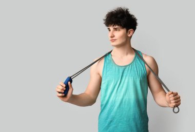 Beyaz arka planda ip atlayan sporcu.