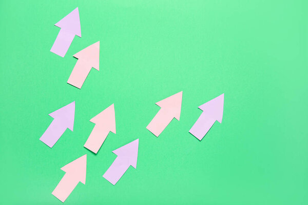 Paper arrows on green background. Price rise concept