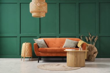 Kırmızı kanepesi, masası ve lambaları olan şık bir oturma odası.