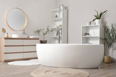 Küvet, raf ünitesi, banyo içinde lavabo ve banyo malzemeleri olan ahşap çekmece.