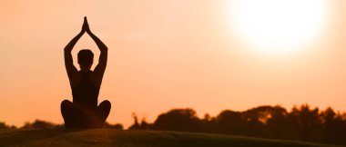 Young woman practicing yoga outdoors in the morning
