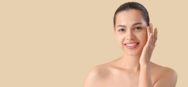 Beautiful young woman on beige background with space for text. Skin care concept