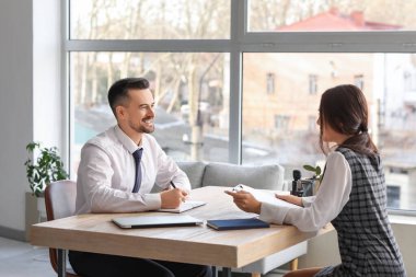 Human resources manager interviewing female applicant in office