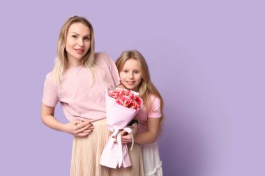 Annesiyle çok tatlı bir kız ve anneler günü için arkaplanda bir buket leylak.