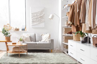 Interior of modern wardrobe with stylish clothes and accessories