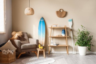 Interior of living room with surfboard and paddle. Summer composition