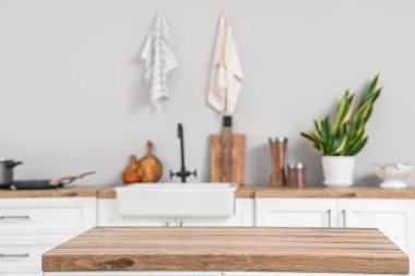 Clean wooden counter in interior of light kitchen