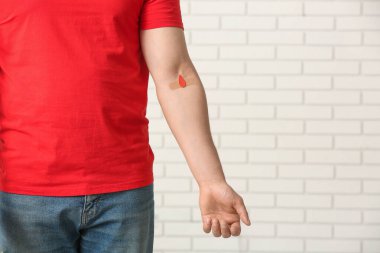 Blood donor with applied medical patch in clinic