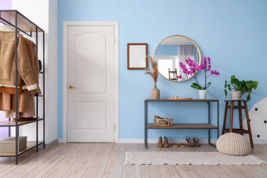 Interior of hall with mirror and orchid flower on shelf