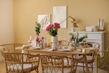 Beautiful table setting with flowers and candles for wedding celebration in room