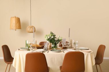 Beautiful table setting with eustoma flowers for wedding celebration in room