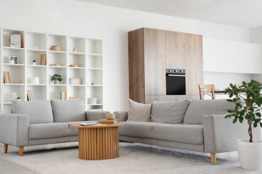 Interior of modern kitchen with sofas and table