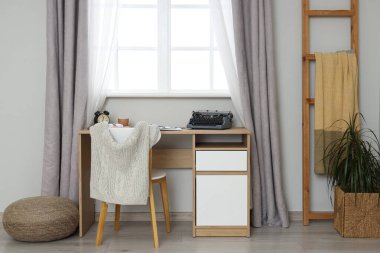 Vintage typewriter on table in author's office interior
