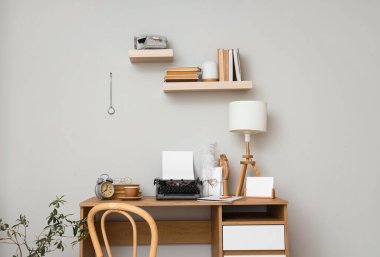 Vintage typewriter and lamp on table in author's office