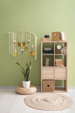 Interior of living room with shelf unit and typewriter
