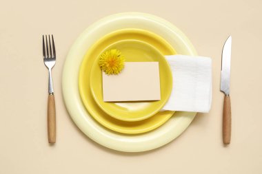 Beautiful table setting with dandelion flower on beige background