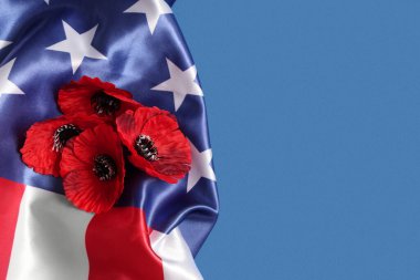 Flag of USA and poppy flowers on blue background, closeup. Memorial Day celebration