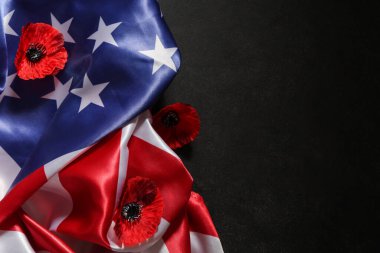 Flag of USA and poppy flowers on dark background, closeup. Memorial Day celebration