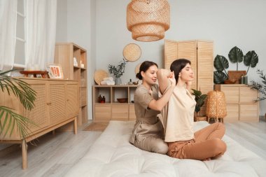 Young woman getting Thai massage on mattress in spa salon