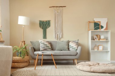 Interior of cozy living room with sofa and wall tapestries