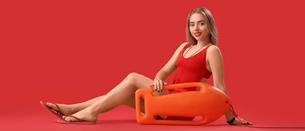 stock image Female beach rescuer on red background