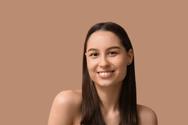 stock image Young dark-haired woman on beige background