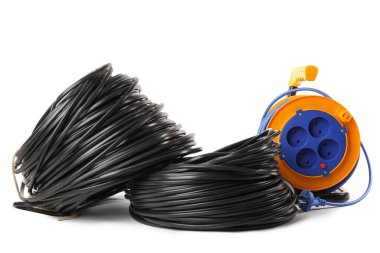 Beyaz arkaplanda rulo kablolar ve uzatma kablosu makarası