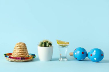Meksika marakkalı kaktüs, mavi arka planda sombrero ve tekila. Cinco de Mayo