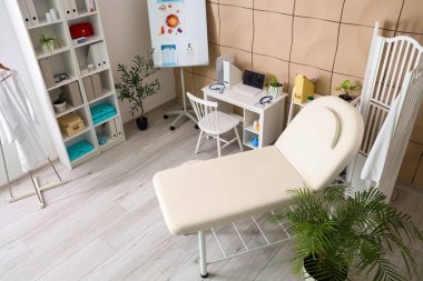 Kanepe, katlama ekranı ve doktorların çalışma yeri olan sağlık bürosu.