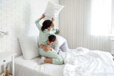 Genç çift yatak odasında kavga ediyor.