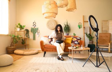 Evde glukofon kayıt videosu olan genç Afro-Amerikan cadı.