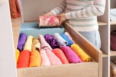 Evde kıyafetleri katlayan kadın.