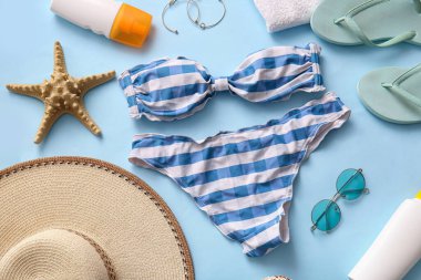 Renkli arka planda şık bayan mayoları ve plaj aksesuarları olan kompozisyon