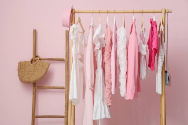 Pembe duvarın yanında şık elbiselerle dizilin.